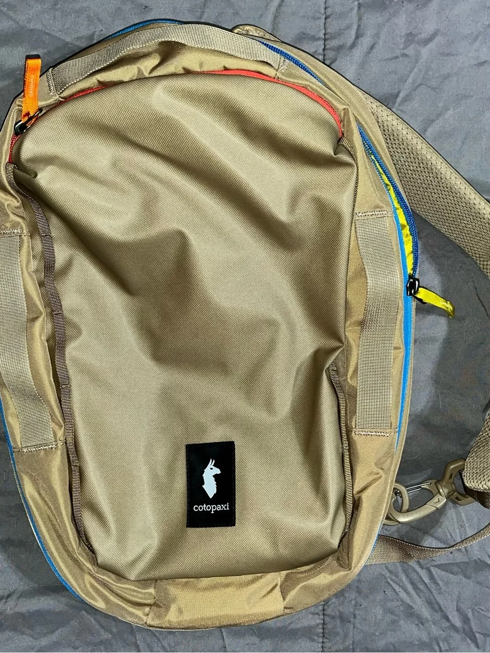 cotopaxi Tan Backpack with Blue Zipper and Multicolor Pulls